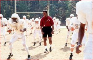 Coach Herman Boone (Washington) commands the drills of the  racially integrated football team.